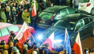 People block the exit from Polish Parliament during an anti-government demonstration in Warsaw, yesterday.