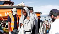 This handout picture taken and released by the Italian Red Cross on October 22 2016 shows migrants landing in Vibo Marina, after a rescue operation in the Mediterranean Sea (AFP) 