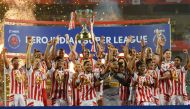 Atletico de Kolkata players celebrate with the trophy after winning the Indian Super League (ISL) final football match against Kerala Blasters FC at the Jawahar Lal Nehru Stadium in Kochi on December 18, 2016. (AFP / SAJJAD HUSSAIN)
