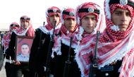 Guard of honor carry a picture of Lieutenant Colonel Saed Mayateh, who was killed during an attack yesterday, during his funeral in the city of Karak, Jordan, December 19, 2016. REUTERS/Muhammad Hamed