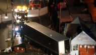 A tow truck operates at the scene where a truck ploughed through a crowd at a Christmas market on Breitscheidplatz square near the fashionable Kurfuerstendamm avenue in the west of Berlin, Germany, December 20, 2016. Reuters/Fabrizio Bensch