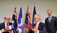 Australian Prime Minister Malcolm Turnbull (right) and French Minister for Defence Jean-Yves Le Drian (left) attending the signing of the Inter-Governmental Agreement.PHOTO: REUTERS.
