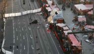 Overall view shows the area of the Christmas market area and the destroyed booths targeted by an attack with a truck ago in front of the Kaiser-Wilhelm-Gedaechtniskirche (Kaiser Wilhelm Memorial Church) in Berlin on December 21, 2016. / AFP.