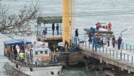Russian Emergencies Ministry members work at a quay of the Black Sea near the crash site of Russian military Tu-154 plane, in the Sochi suburb of Khosta, Russia, Russia December 25, 2016. REUTERS.