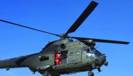 A soldier from Resolute Support (RS) troops dressed as Santa Claus, waves from a military helicopter during a football match to commemorate the Christmas Truce of 1914 at the ISAF Headquarters, in Kabul, Afghanistan December 25, 2016. REUTERS/Omar Sobhani