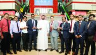 Ajayan Al Marri, an official from the Ministry of Economy and Commerce, with senior officials of Quality Hypermarket Group, after a raffle draw of the Shop and Drive sales promotion, at the Quality Mall, Al Hilal, in Doha yesterday. The winners of the dra