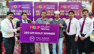 Rafeek, the first raffle draw winner of ‘Malabar Gold & Diamond Festival’’, receives the prize of 250 gramme gold from Saji P K, Branch Manager at Gharafa-Qatar, in the presence of officials from Malabar Gold & Diamonds.