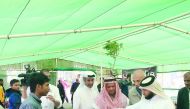 Yousuf Al Khulaifi, Director, Agricultural Affairs Department, visiting a honey stall at the winter vegetable market in Al Mazrouah Yard, in Umm Salal, yesterday.