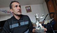 This file photo taken on February 20, 2013 shows Bosnian Roma actor Nazif Mujic (42) holding his Silver Bear prize from 2013 Berlinale, in his home in village of Svatovac. Silver bear award winning Bosnian Roma actor Nazif Mujic stated on January 6, 2017 