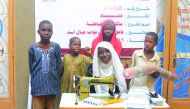 A beneficiary family with a sewing machine provided by Qatar Charity as part of its humanitarian projects in Chad.