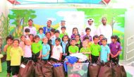 Schoolchildren with in-kind donations provided to QC for poor workers.