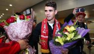 (FILES) This file photo taken on January 2, 2017 shows Brazilian football player Oscar (C) receiving flowers as he arrives at Shanghai airport. Brazilian midfielder Oscar landed in Shanghai on January 2, 2017 where the 25-year-old was set to smash the Asi