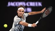 Switzerland's Roger Federer hits a return against Austria's Jurgen Malzer during their men's singles match on day one of the Australian Open tennis tournament in Melbourne on January 16, 2017. AFP / PETER PARKS