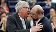European Commission President Jean-Claude Juncker (L) and former President of the European Parliament President Martin Schulz embrace during a debate on the priorities of the incoming Malta Presidency of the EU for the next six months at the European Parl