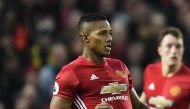 Manchester United's Ecuadorian midfielder Antonio Valencia (L) vies with Liverpool's Brazilian midfielder Roberto Firmino during the English Premier League football match between Manchester United and Liverpool at Old Trafford in Manchester, north west En