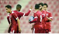 Qatar Olympic team players celebrate a goal against Hong Kong during their friendly game in Doha on Tuesday night. 