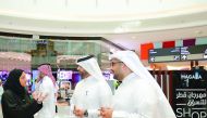 Hassan Al Ibrahim, QTA’s Chief Tourism Development Officer (right); Abdulaziz bin Nasser Al-Khalifa, CEO of Qatar Development Bank (second right), and Mashal Shahbik, QTA's Festivals and Tourism Events Director, during a tour of the pop-up shops at Mall o