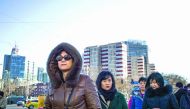 People walking in the street on their way to work in Beijing.