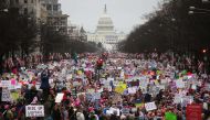 Protesters walk up Pennsylvania Avenue during the Women's March on Washington, with the U.S. Capitol in the background, on January 21, 2017 in Washington, DC. Large crowds are attending the anti-Trump rally a day after U.S. President Donald Trump was swor