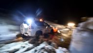 A volunteer from Ticino, Switzerland, clears the road with his own car snow plow in the village of Castelli, some 15 km from the site where an avalanche engulfed the mountain hotel Rigopiano in Farindola, near Penne, in earthquake-ravaged central Italy, o