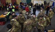 Italian soldiers gather at the rescue operations center in Penne, some 20 km from the site of an avalanche that engulfed the Hotel Rigopiano in heavy snow and earthquake-ravaged central Italy, on January 23, 2017. Italian rescuers pulled nine survivors fr
