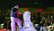 Visitors enjoy ice carving at the fourth Katara Winter Festival at Katara Cultural Village, yesterday.