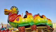 Children enjoy Caterpillar ride at Al Ahmed Square on the last day of Souq Waqif Spring Festival yesterday. Pic: Raynald C Rivera / The Peninsula
