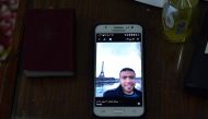 A picture taken on February 5, 2017, shows a picture of Abdallah El-Hamahmy, an Egyptian suspected of being the machete attacker in Paris's Louvre museum, displayed on a phone at the family home in the Nile delta city of Mansura, some 120 kms north of Cai