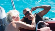 Former U.S. President Barack Obama and British businessman Richard Branson sit on a boat during Obama's holiday on Branson's Moskito island, in the British Virgin Islands, in a picture handed out by Virgin on February 7, 2017. Jack Brockway/Virgin Handout