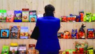 A visitor looks at a presentation shelf during the opening day of the 