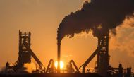The sun rising above Tata Steels blast furnaces at their Scunthorpe Plant in north east England (AFP file photo / LINDSEY PARNABY) 