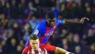 Barcelona defender Samuel Umtiti vies with Atletico Madrid's forward Kevin Gameiro during the Spanish Copa del Rey semi-final second leg match at the Camp Nou Stadium in Barcelona on Thursday.