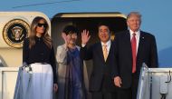 President Donald Trump and his wife Melania Trump arrive with Japanese Prime Minister Shinzo Abe and his wife Akie Abe on Air Force One at the Palm Beach International airport as they prepare to spend part of the weekend together at Mar-a-Lago resort on F