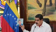 Venezuela's President Nicolas Maduro holds an image of Venezuela's late President Hugo Chavez as he speaks during a meeting with governors in Caracas, Venezuela February 14, 2017. Miraflores Palace/Handout 
