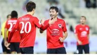 Al Rayyan's Rodrigo Tabata (right) celebrates with team-mate Myongin Koh after scoring one of his goals during their QSL match against Muaither SC yesterday. 