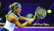 Puerto Rican Olympic champion  Monica Puig returns a shot to Russian teenager  Daria Kasatkina during their Qatar Total Open  Quarter-final played at the Khalifa International Tennis  Complex in Doha yesterday. Puig made a remarkable  fight back to beat K