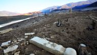 This picture taken on February 16, 2017, shows a the ruins of a sunken mosque and nearby graveyards as evidence of human habitation in the past on the dried-out lake bed of artificial Ramsko lake near the Bosnian town of Prozor, some 120 km west of Saraje