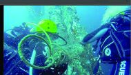 Divers removing waste from the sea. 