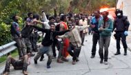 Migrants celebrate outside the Center for Temporary Stay of Immigrants (CETI) after forcing their way through fence between Morocco and Spanish enclave of Ceuta, on February 17, 2017 (AFP Photo/Antonio Sempere).