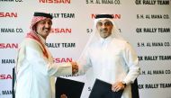 Adel Hussein, the world rally champion and Hisham Saleh Al Mana, Chairman and Managing Director of Nissan shake hands after renewing the deal between Nissan and QX Rally Team at the main Nissan showroom in Doha.Picture: Baher Amin/The Peninsula