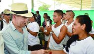 Colombian President Juan Manuel Santos (left) shaking hands with a FARC-EP leftist guerrilla during his visit to a Transitional Standardization Zone in La Carmelita, Puerto Asis municipality, yesterday.