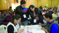 Members of the National Electoral Council count votes in Quito yesterday. 