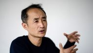 In this picture taken on February 8, 2017, Chinese film-maker Wen Hai, 46, gestures during an interview on his documentary 