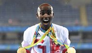 (FILES) This file photo taken on August 21, 2016 shows gold medallist Britain's Mo Farah celebrating near the podium for the Men's 5000m during the athletics event at the Rio 2016 Olympic Games at the Olympic Stadium in Rio de Janeiro on August 20, 2016. 