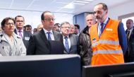 French President Francois Hollande (3rd L) visits a control room as he attends the inauguration of the new 