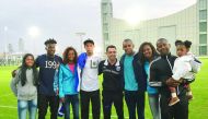 Football legend Xavi Hernandez (centre) poses for a photograph with Shine athletes at Al Sadd training ground. 