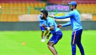 Indian cricketers KL Rahul (left) and Karun Nair stretch during a practice session prior to the second Test against Australia at the M Chinnaswamy Stadium in Bangalore yesterday.