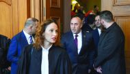 Former Kosovo prime minister Ramush Haradinaj (centre) leaves the courthouse of Colmar yesterday after the appeal court hearing in his extradition case, next to his lawyer Rachel Lindon (second left). Haradinaj was arrested in France in January under an i