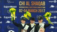 The podium winners of the CDI5* GP FS - Grand Prix Freestyle to Music (GP FS) dressage event of CHI Al Shaqab, Isabell Werth, Cathrine Dufour and Anna Kasprzak pose for a photograph with officials after the presentation ceremony at the Al Shaqab Arena yes