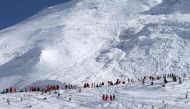 (FILES) This file handout photo taken and realeased on February 13, 2017 and made available by Radio Val d'Isere in Tignes, in the French Alps shows an avalanche site in an off-piste area after an avalanche engulfed nine people, killing at least four.  AF